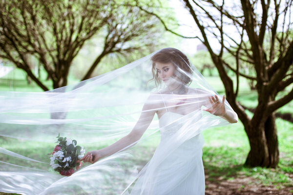 Blonde bride in fashion white wedding dress with makeup