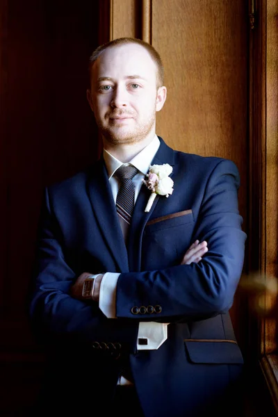 Stilig brudgummen i kostym i hallen — Stockfoto