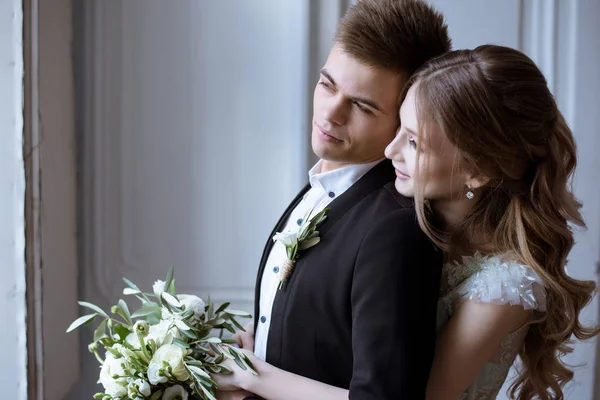 Pareja de boda en el interior es abrazarse entre sí —  Fotos de Stock