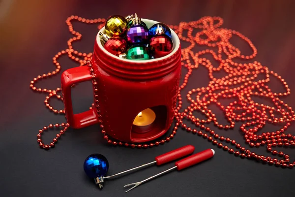 New Year's decor. The concept of the New Year holiday. Christmas decor. 2017. The drink. New Year, Christmas toys in a cup, fondue. Christmas background. New Year background. Red cup