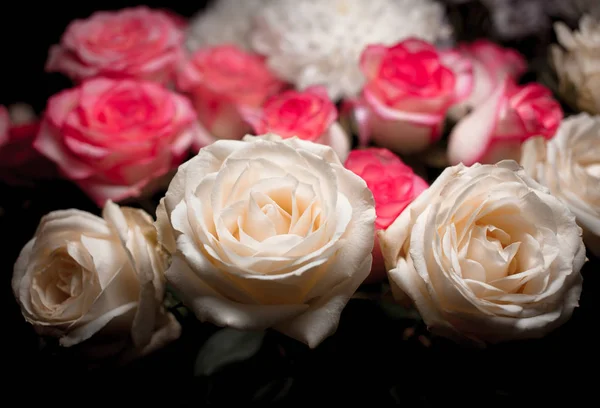 Still life of rose bouquet flower. Beautiful fresh pink roses. Rose Posy Wedding Bouquet. heap of pink and white fresh roses. Street flower market. Different roses on a black background