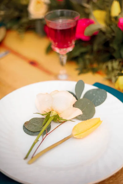 Beautifully decorated table for the wedding ceremony. Served banquet table decorated with fresh flowers in the open air.