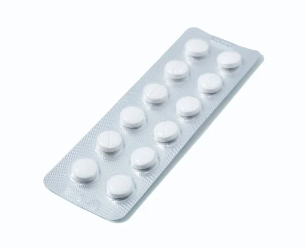 Aluminium blister pack of pills. The capsules are packaged in blisters, isolated on a white background. Disease. Flu. Medications. — Stock Photo, Image