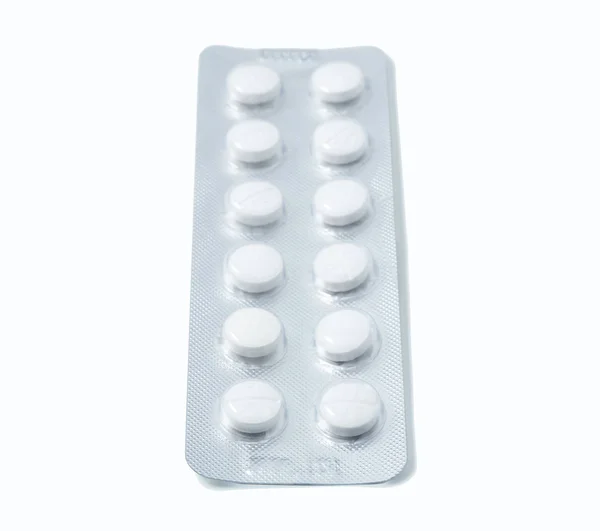 Aluminium blister pack of pills. The capsules are packaged in blisters, isolated on a white background. Disease. Flu. Medications. — Stock Photo, Image