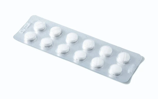 Aluminium blister pack of pills. The capsules are packaged in blisters, isolated on a white background. Disease. Flu. Medications. — Stock Photo, Image