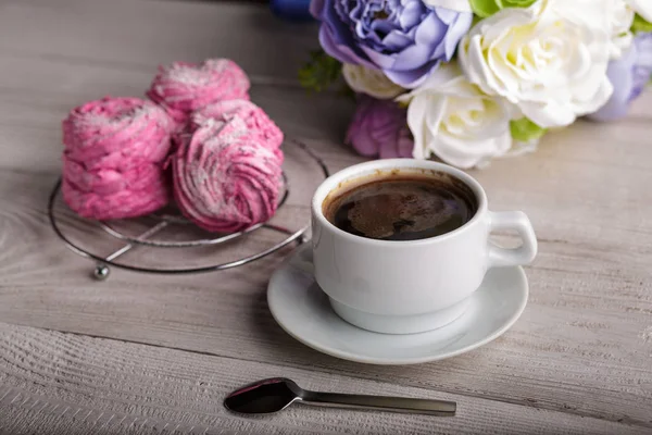 Black coffee and pink zephyr. marshmallow. Sweet pink marshmallow - zephyr and cup of Coffee. Christmas Still Life. Winter drink theme. Romance. Provencal still life. Good morning