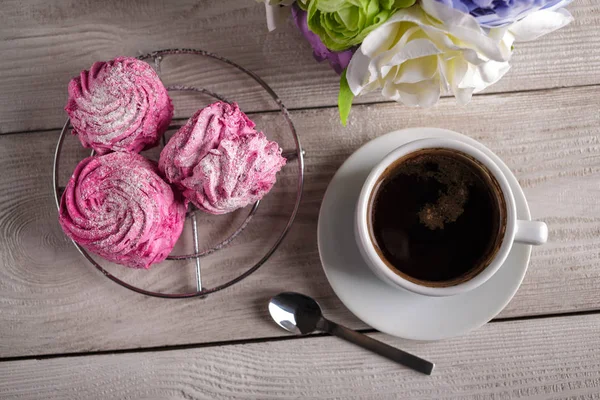 Black coffee and pink zephyr. marshmallow. Sweet pink marshmallow - zephyr and cup of Coffee. Christmas Still Life. Winter drink theme. Romance. Provencal still life. Good morning