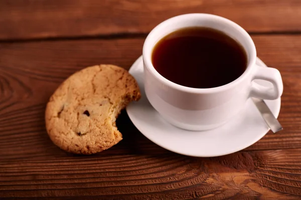 Coffee and Homemade cookies with chocolate. Handmade Chocolate cookies and cup of espresso on wooden table. Pile of delicious chip cookies. Christmas cookies. Biscuits. Oat biscuits.