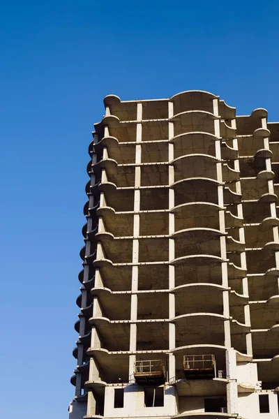 Yarım kalmış çimento bir inşaat alanında bina. Yeni çok katlı bina. Çok uzun boylu bir gökdelenin bir ofis binası olarak kullanılmak üzere inşaat faaliyeti.