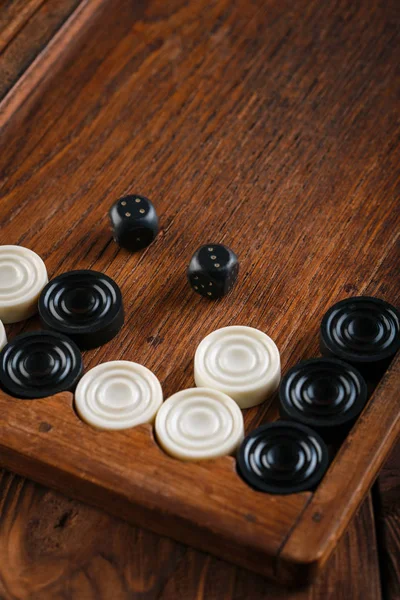 Backgammon. Game field in a backgammon with cubes and counters. Game concept. Board game. Hobby. Dice and checkers on the playing field for a game of backgammon.