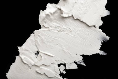 Yapısal Alçı beyaz siyah bir arka plan. Beyaz krema. boya karalama. Hamuru.