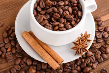 Kahve çekirdekleri ve tarçın çuval bezi bir arka plan üzerinde. Kavrulmuş kahve çekirdekleri arka plan kapatın. Üst metin kopyalama yeri olan kahve çekirdekleri kazık. Baharat. Baharat. Tarçın. Badian. Kahve evi.