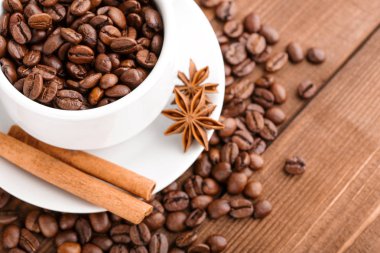 Kahve çekirdekleri ve tarçın çuval bezi bir arka plan üzerinde. Kavrulmuş kahve çekirdekleri arka plan kapatın. Üst metin kopyalama yeri olan kahve çekirdekleri kazık. Baharat. Baharat. Tarçın. Badian. Kahve evi.