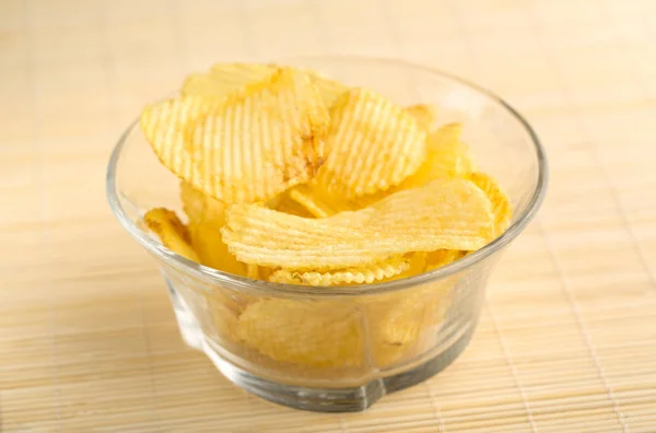 Crispy potato chips. Fast Food. Potatoes. Fatty unhealthy foods. corrugated chips