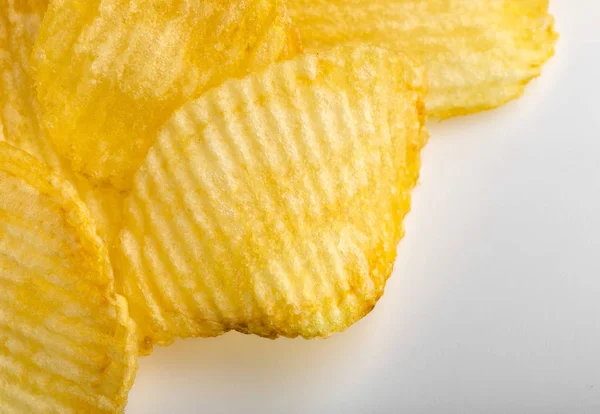 Crispy potato chips. Fast Food. Potatoes. Fatty unhealthy foods. corrugated chips