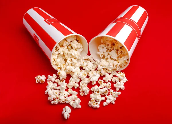 Popcorn in red and white cardboard box. Popcorn border isolated on white. Film. Fast food. Corn