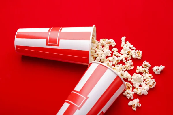 Popcorn in red and white cardboard box. Popcorn border isolated on white. Film. Fast food. Corn