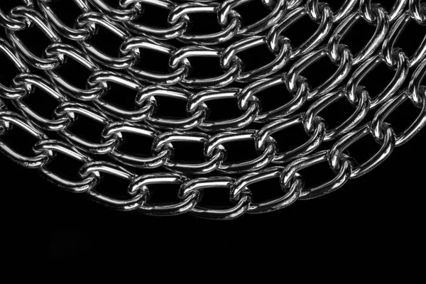 Chain heap - abstract metal background. Collection silver jewelry chains on an isolated black background. Set of different lenght metal chain. Accessories. Bijouterie. Silver.