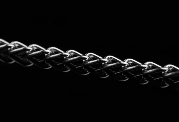 Chain heap - abstract metal background. Collection silver jewelry chains on an isolated black background. Set of different lenght metal chain. Accessories. Bijouterie. Silver.