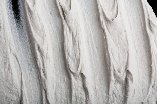 Yapısal Alçı beyaz siyah bir arka plan. Beyaz krema. boya karalama. Hamuru