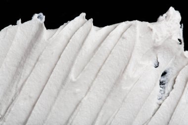 Yapısal Alçı beyaz siyah bir arka plan. Beyaz krema. boya karalama. Hamuru