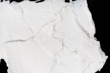 Yapısal Alçı beyaz siyah bir arka plan. Beyaz krema. boya karalama. Hamuru