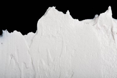 Yapısal Alçı beyaz siyah bir arka plan. Beyaz krema. boya karalama. Hamuru