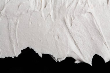 Yapısal Alçı beyaz siyah bir arka plan. Beyaz krema. boya karalama. Hamuru