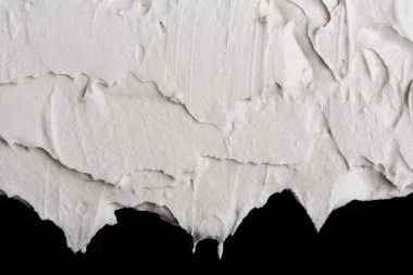 Yapısal Alçı beyaz siyah bir arka plan. Beyaz krema. boya karalama. Hamuru