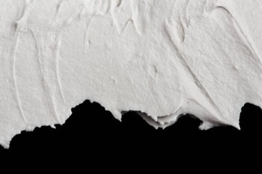 Yapısal Alçı beyaz siyah bir arka plan. Beyaz krema. boya karalama. Hamuru