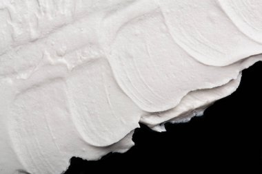 Yapısal Alçı beyaz siyah bir arka plan. Beyaz krema. boya karalama. Hamuru