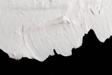 Yapısal Alçı beyaz siyah bir arka plan. Beyaz krema. boya karalama. Hamuru