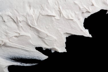 Yapısal Alçı beyaz siyah bir arka plan. Beyaz krema. boya karalama. Hamuru