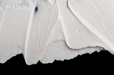 Yapısal Alçı beyaz siyah bir arka plan. Beyaz krema. boya karalama. Hamuru