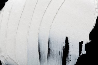 Yapısal Alçı beyaz siyah bir arka plan. Beyaz krema. boya karalama. Hamuru