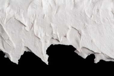 Yapısal Alçı beyaz siyah bir arka plan. Beyaz krema. boya karalama. Hamuru