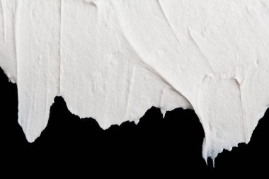 Yapısal Alçı beyaz siyah bir arka plan. Beyaz krema. boya karalama. Hamuru