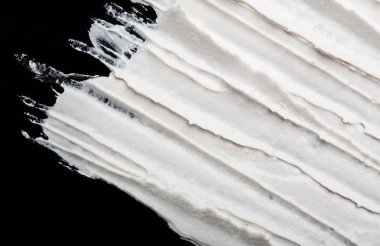 Yapısal Alçı beyaz siyah bir arka plan. Beyaz krema. boya karalama. Hamuru