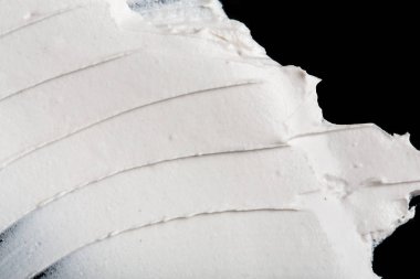 Yapısal Alçı beyaz siyah bir arka plan. Beyaz krema. boya karalama. Hamuru