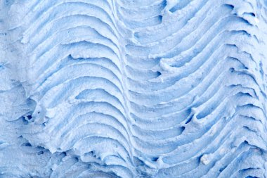 Yapısal sıva üzerinde siyah bir arka plan mavi. Beyaz krema. boya karalama. Hamuru