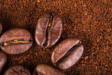 kavrulmuş kahvenin beyaz arka planda izole. Kavrulmuş kahve çekirdekleri arka plan kapatın. Kahve çekirdekleri çekilmiş kahve ile kopya alanı metin için arka plan üzerinde kazık. Günaydın.