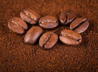 kavrulmuş kahvenin beyaz arka planda izole. Kavrulmuş kahve çekirdekleri arka plan kapatın. Kahve çekirdekleri çekilmiş kahve ile kopya alanı metin için arka plan üzerinde kazık. Günaydın.