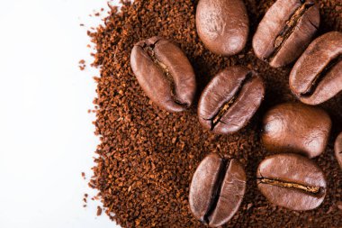 kavrulmuş kahvenin beyaz arka planda izole. Kavrulmuş kahve çekirdekleri arka plan kapatın. Kahve çekirdekleri çekilmiş kahve ile kopya alanı metin için arka plan üzerinde kazık. Günaydın.