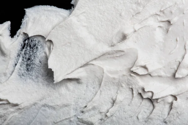 Yapısal Alçı beyaz siyah bir arka plan. Beyaz krema. boya karalama. Hamuru