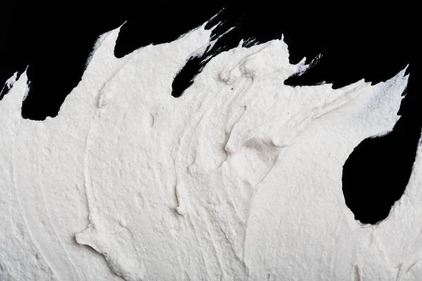 Yapısal Alçı beyaz siyah bir arka plan. Beyaz krema. boya karalama. Hamuru