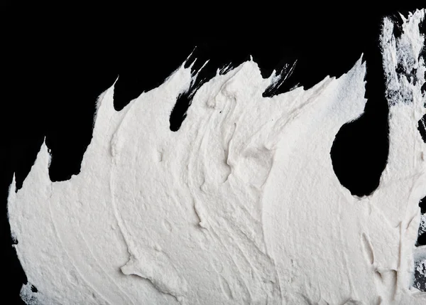 Yapısal Alçı beyaz siyah bir arka plan. Beyaz krema. boya karalama. Hamuru