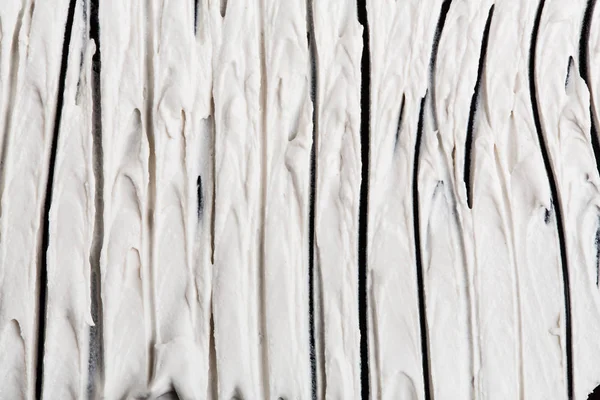 Yapısal Alçı beyaz siyah bir arka plan. Beyaz krema. boya karalama. Hamuru