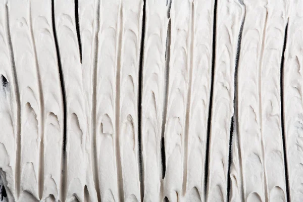 Yapısal Alçı beyaz siyah bir arka plan. Beyaz krema. boya karalama. Hamuru