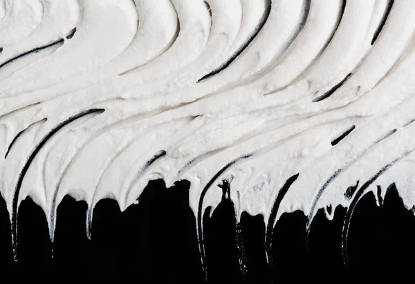 Yapısal Alçı beyaz siyah bir arka plan. Beyaz krema. boya karalama. Hamuru