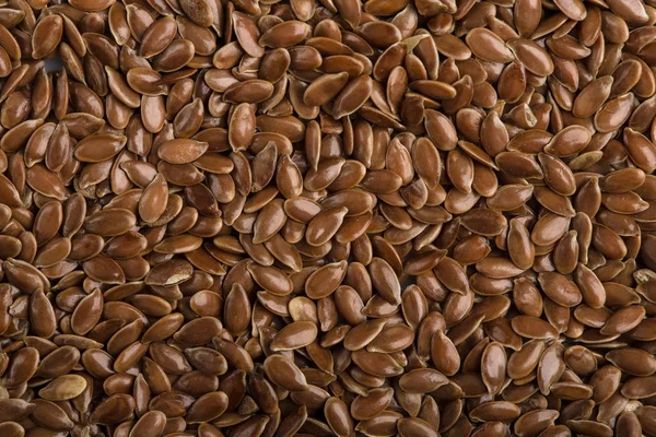 Close up of flax seeds isolated on white background. Bowl full of brown flaxseed or linseed. Cereals. Vitamins. Healthy food. — Stock Photo, Image